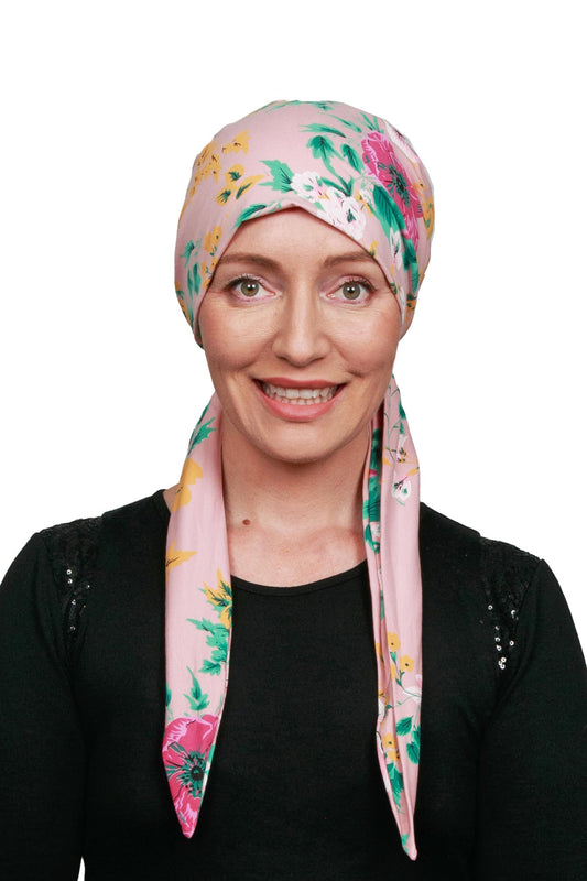 Women wearing a pink and floral cancer head wrap scarf for cancer
