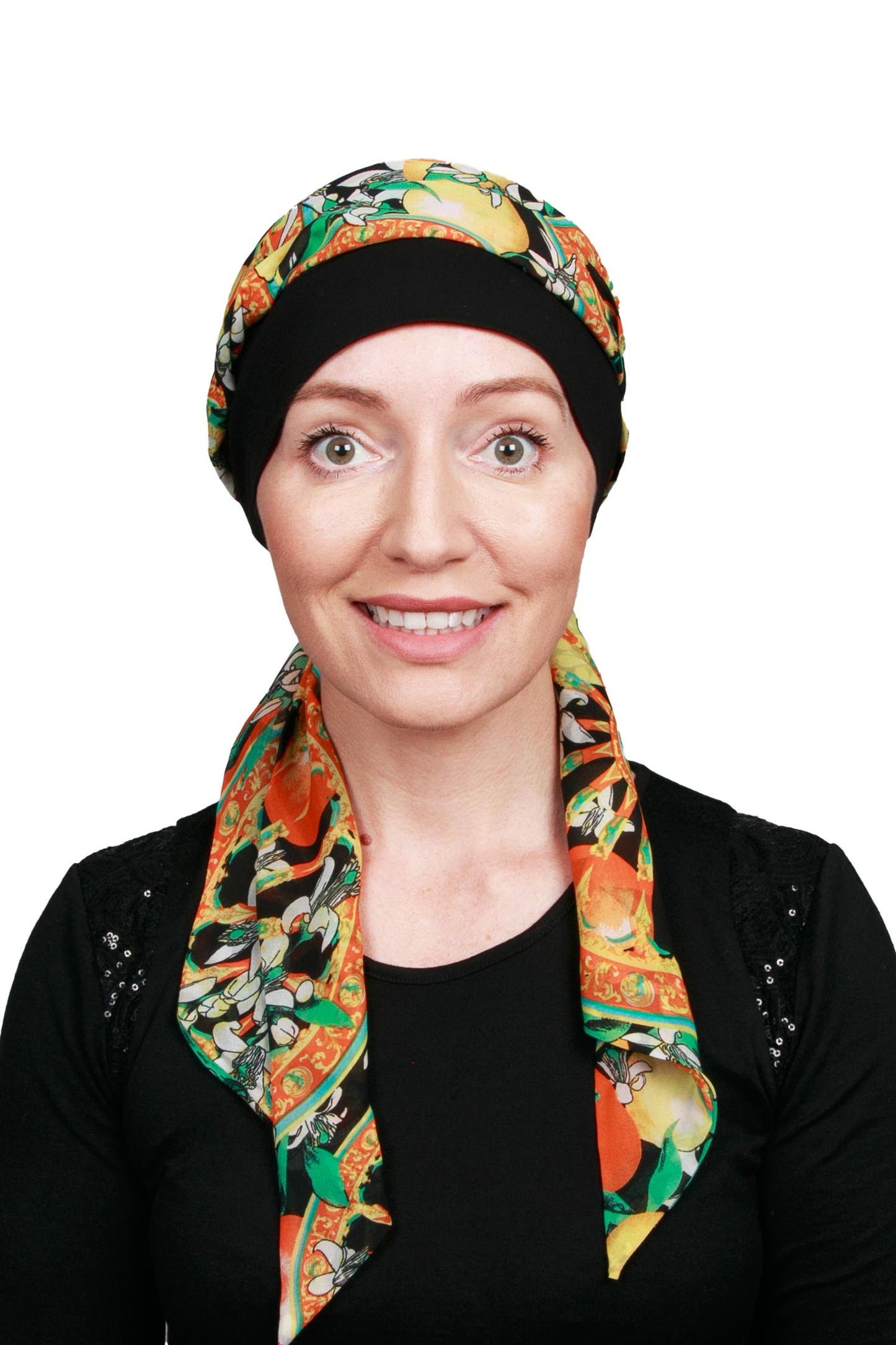 Women wearing a black cap for cancer with a scarf in a floral print as a headwrap in nz