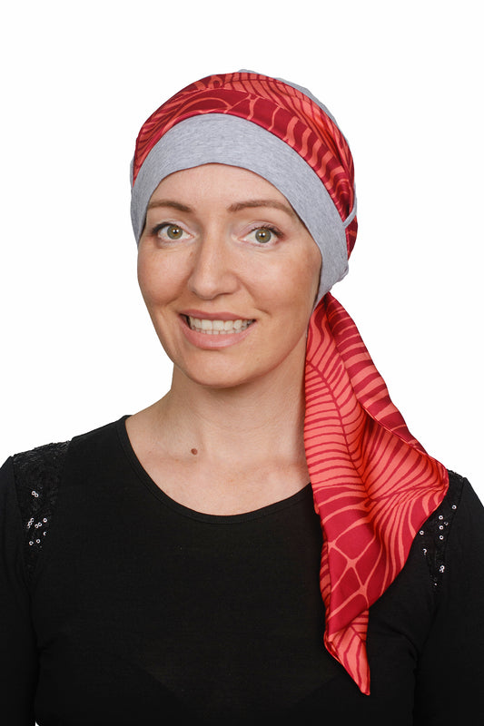 Women wearing a cancer hat in grey marle with a coloured scarf as a head covering