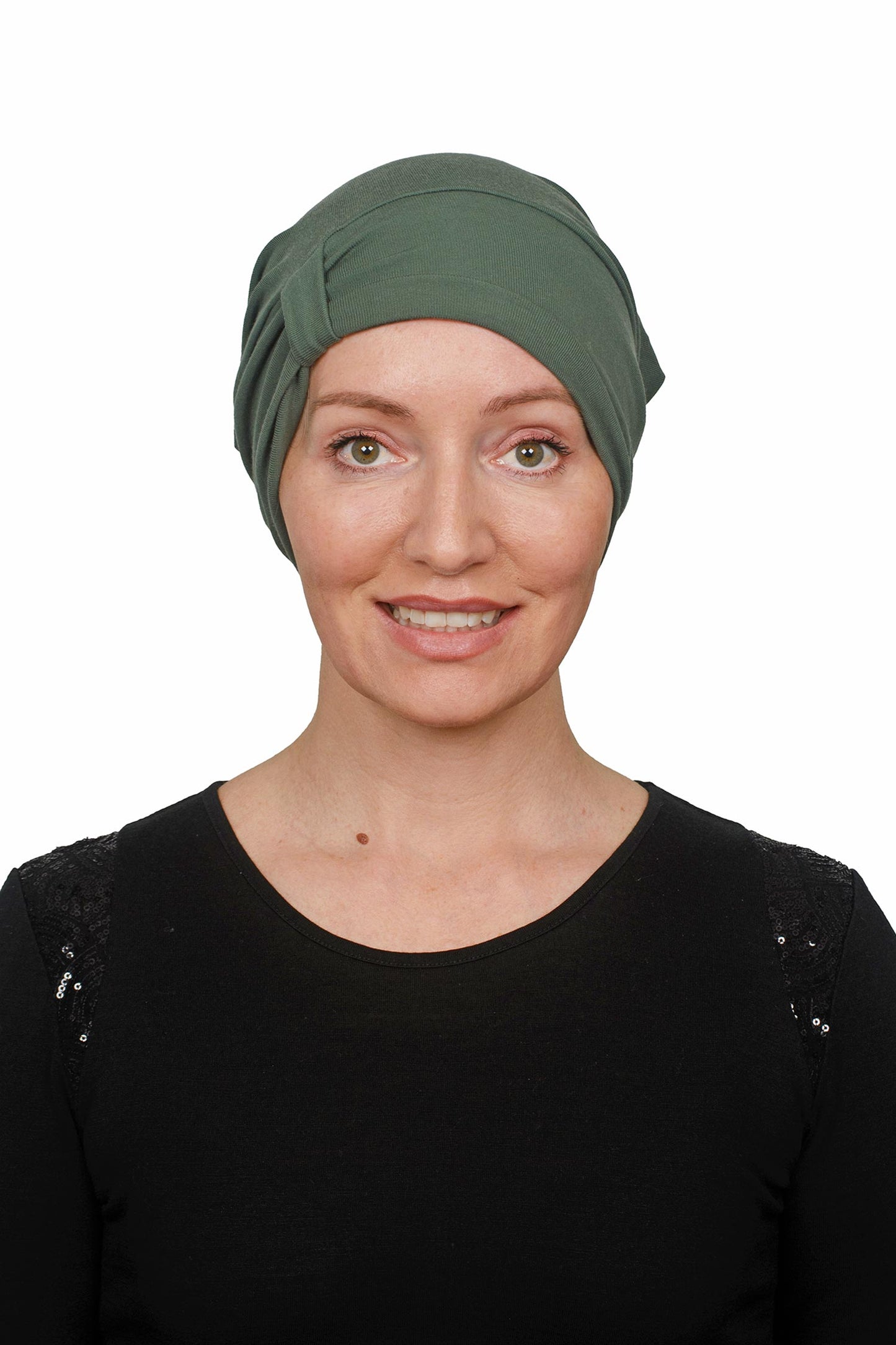 Woman wearing a cancer green headscarf on a white background