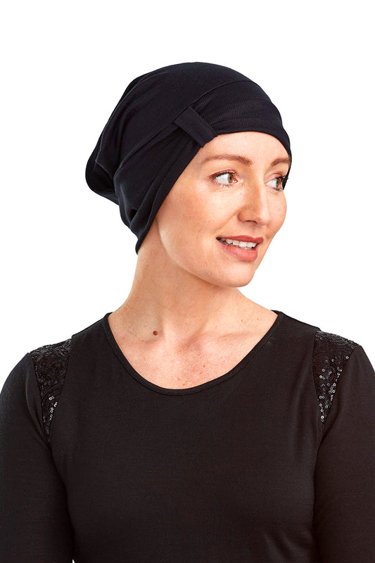 Women wearing a cancer beanie as a head covering
