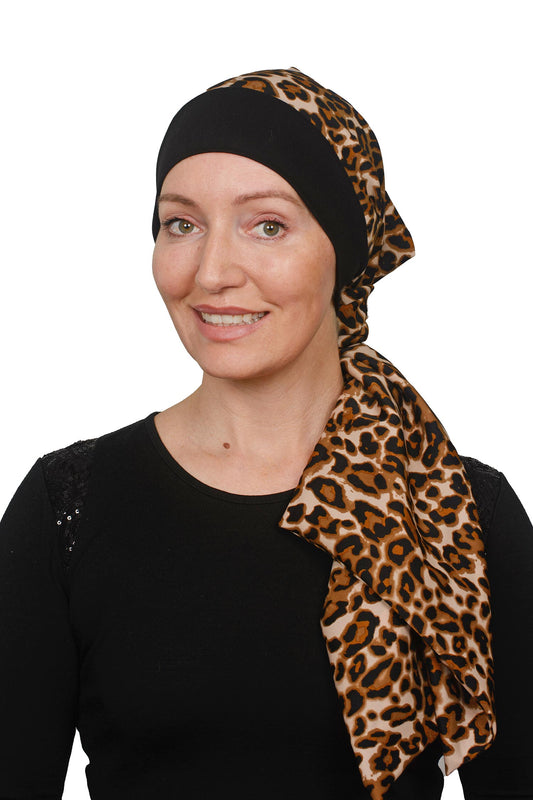 women wearing a cancer head scarf in an animal print with a black band and a scrunchie