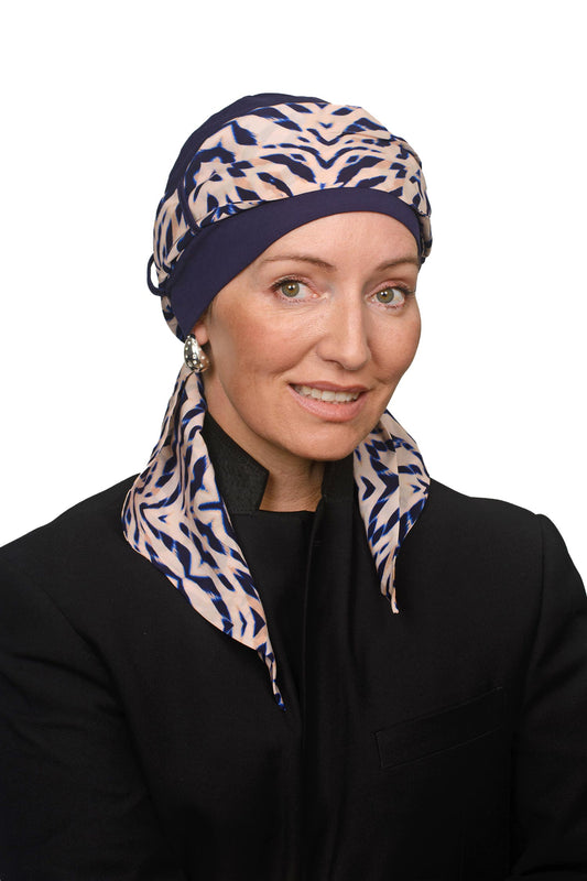 Women wearing an ink cap with a head scarf in a modern animal print for hair loss