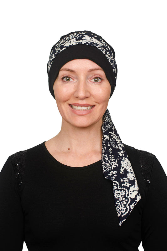Women wearing a black cap with a black and white scarf for cancer as a headwrap