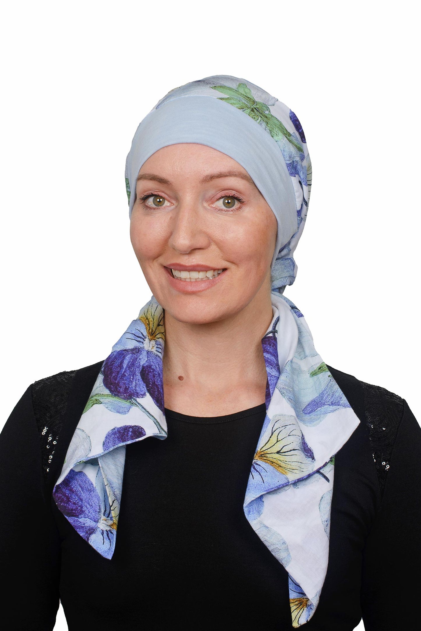 Women wearing a pansy print scarf cancer hat with a scrunchie and worn as a head covering
