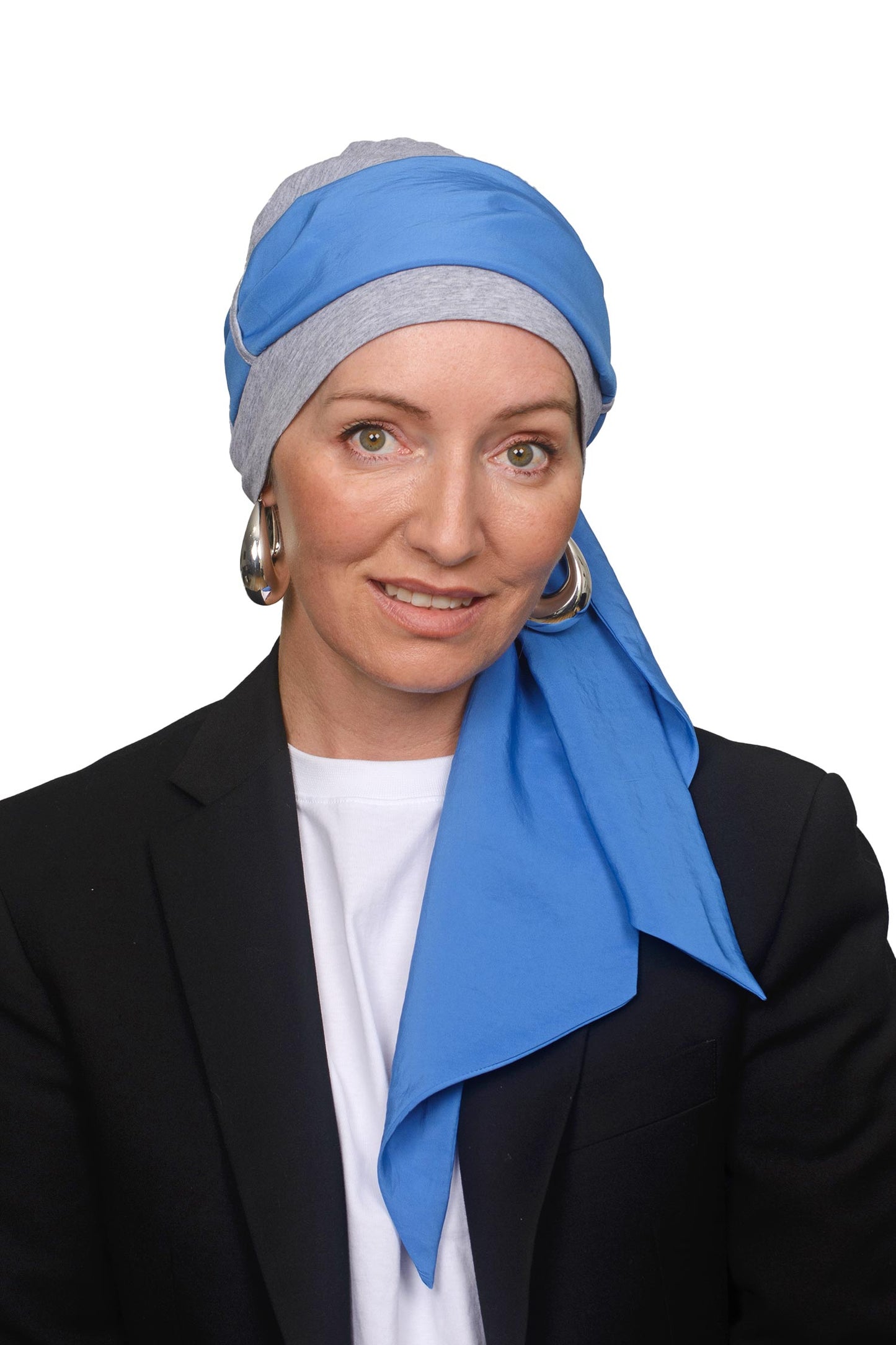 Women wearing a grey silver cap with a blue headscarf in it for cancer as a headcovering2