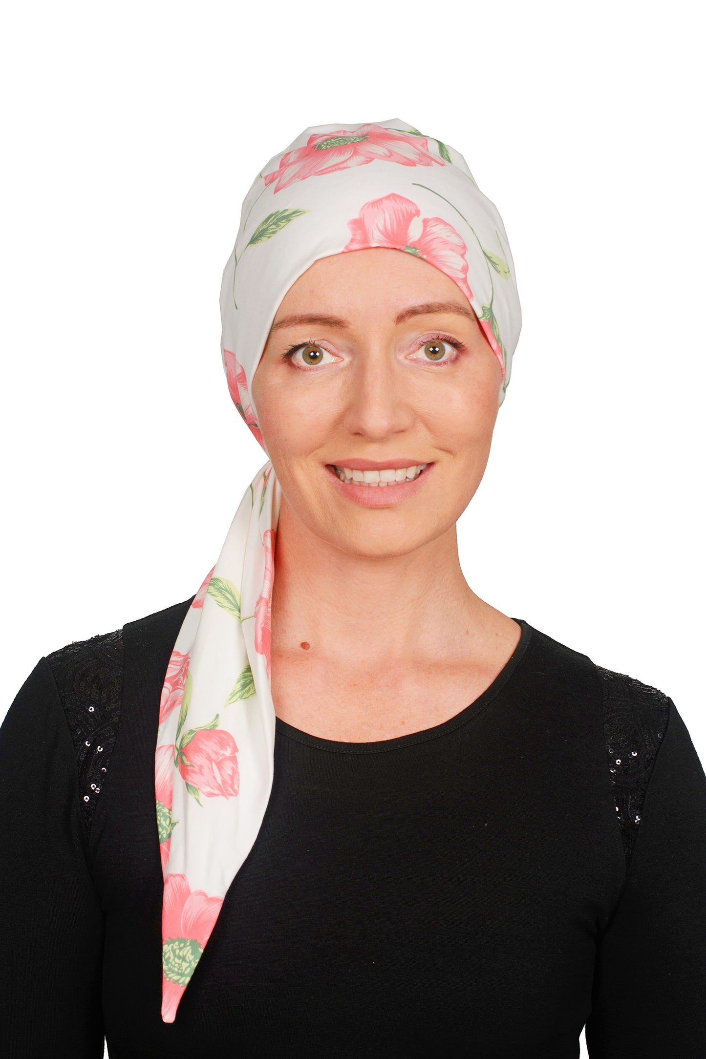 A women wearing a cancer headwrap in cream with pink flowers on it for cancer