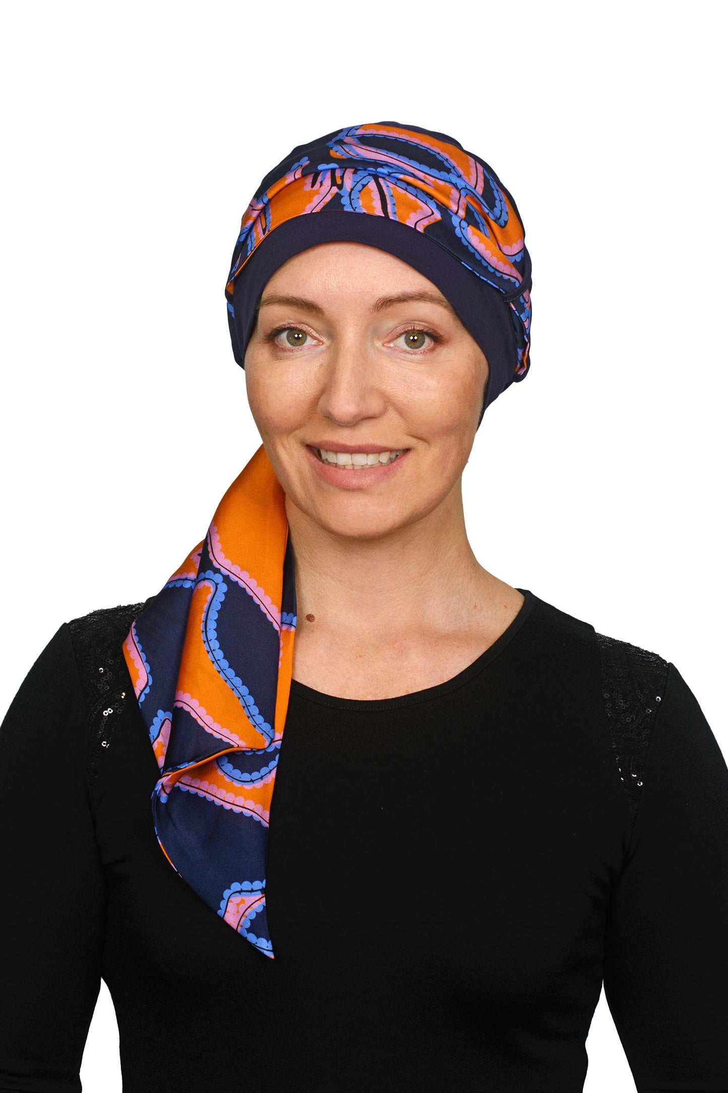 Women wearing an ink cancer hat with a bright coloured scarf headcovering