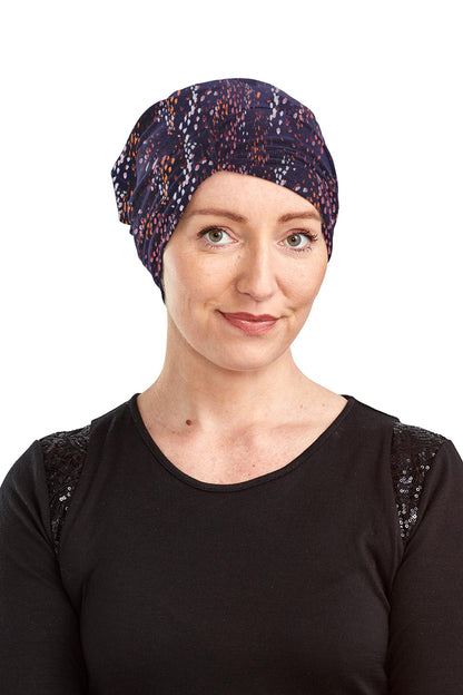 Woman wearing a patterned headscarf on a white background