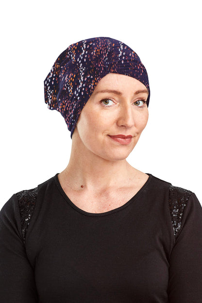 Woman wearing a patterned headscarf on a white background