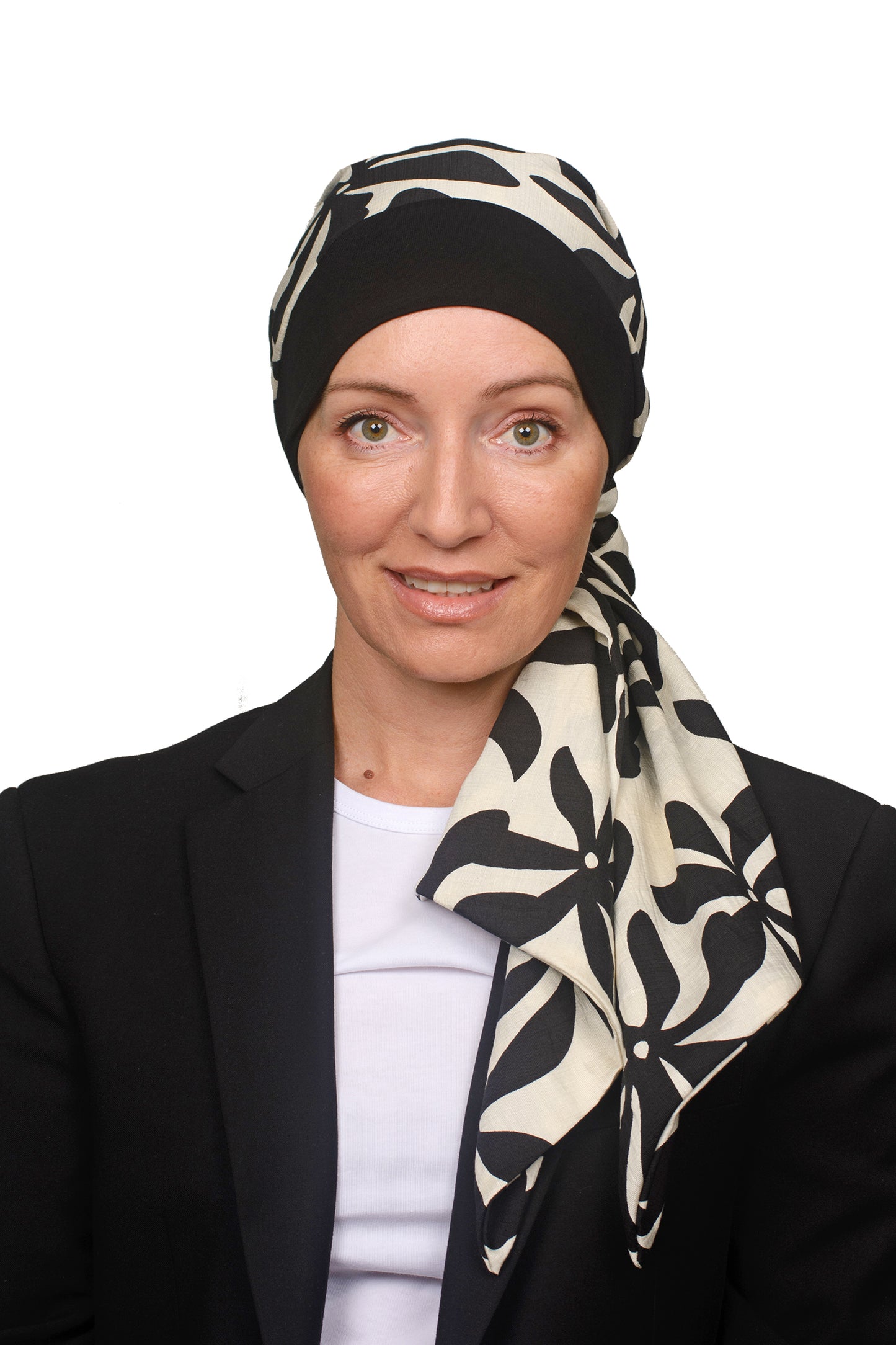 Women wearing a headwrap for cancer in black and creams as head covering