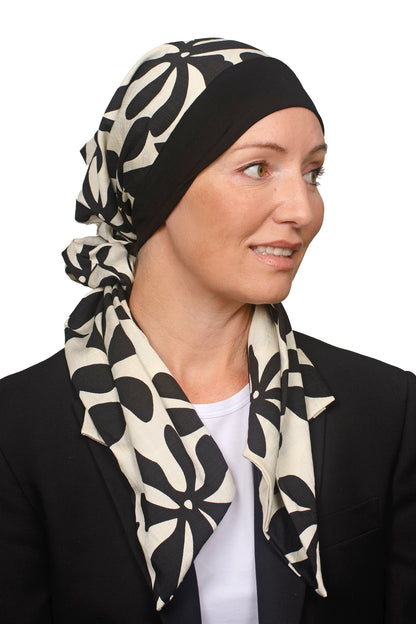 Women wearing a headwrap for cancer in black and creams as head covering