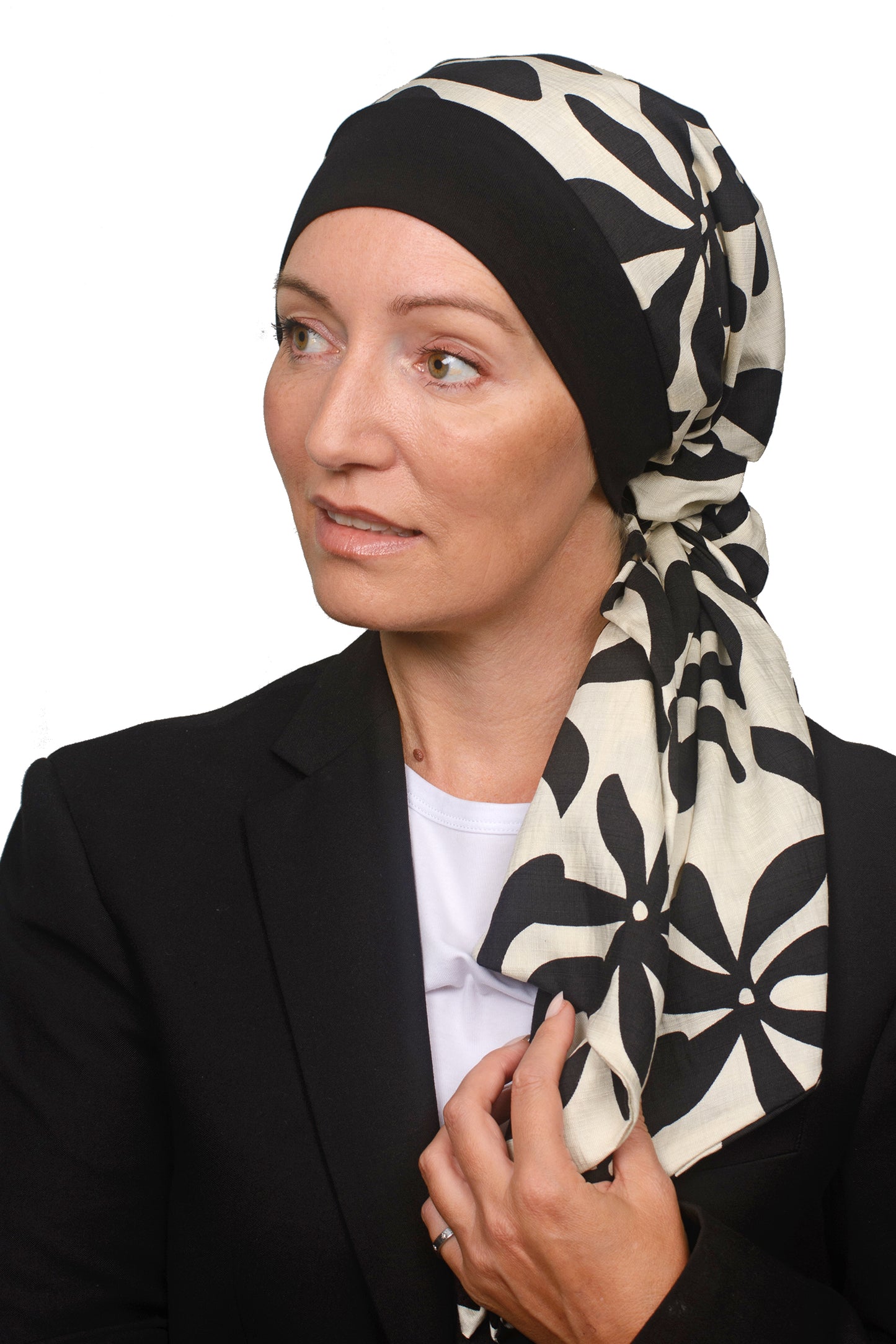 Women wearing a headwrap for cancer in black and creams as head covering