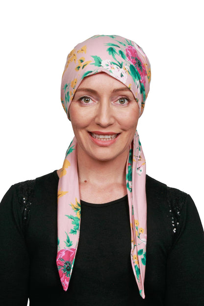 Women wearing a pink and floral cancer head wrap scarf for cancer