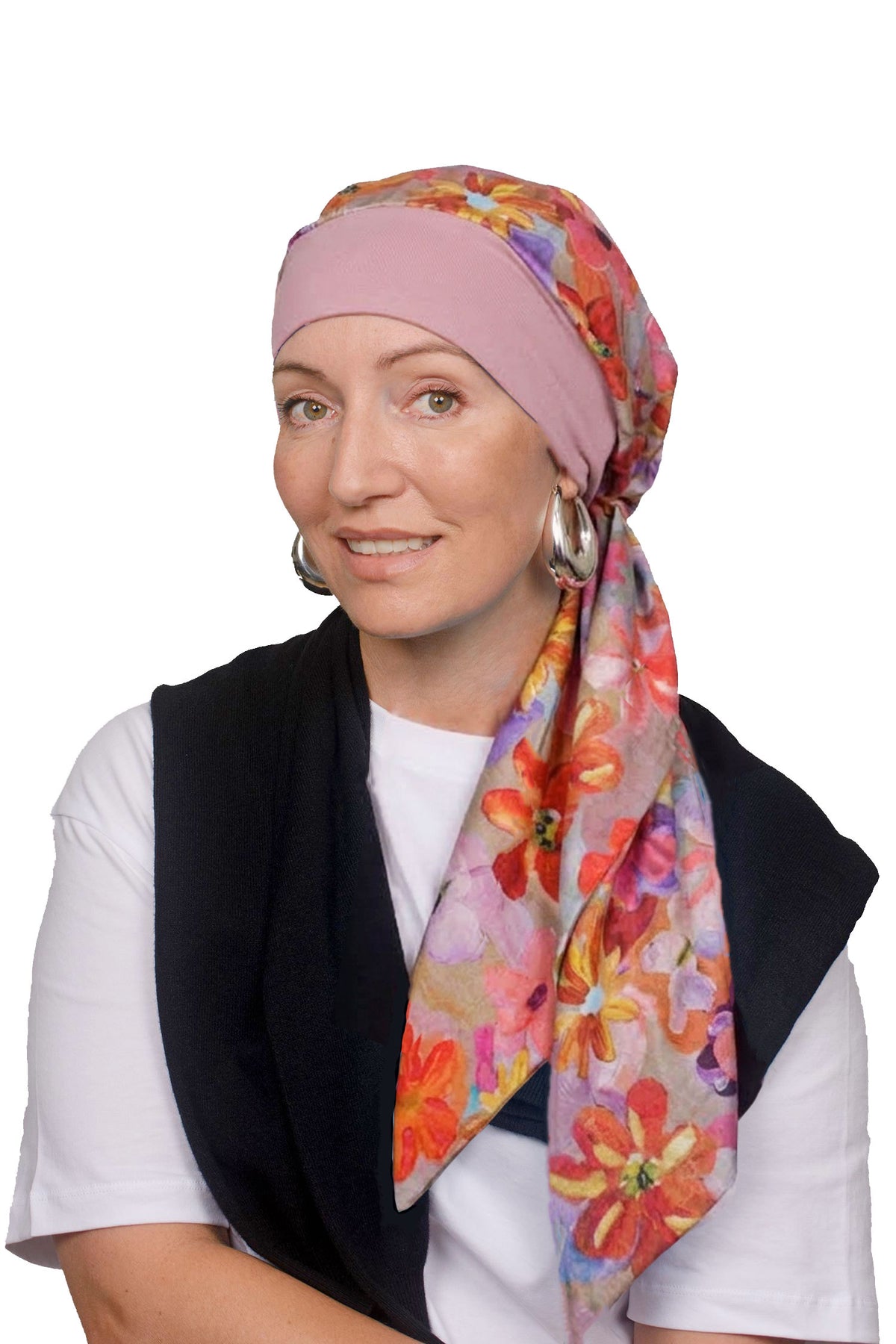 A women wearing a head scarf in pretty pink with a floral design on it as a head covering