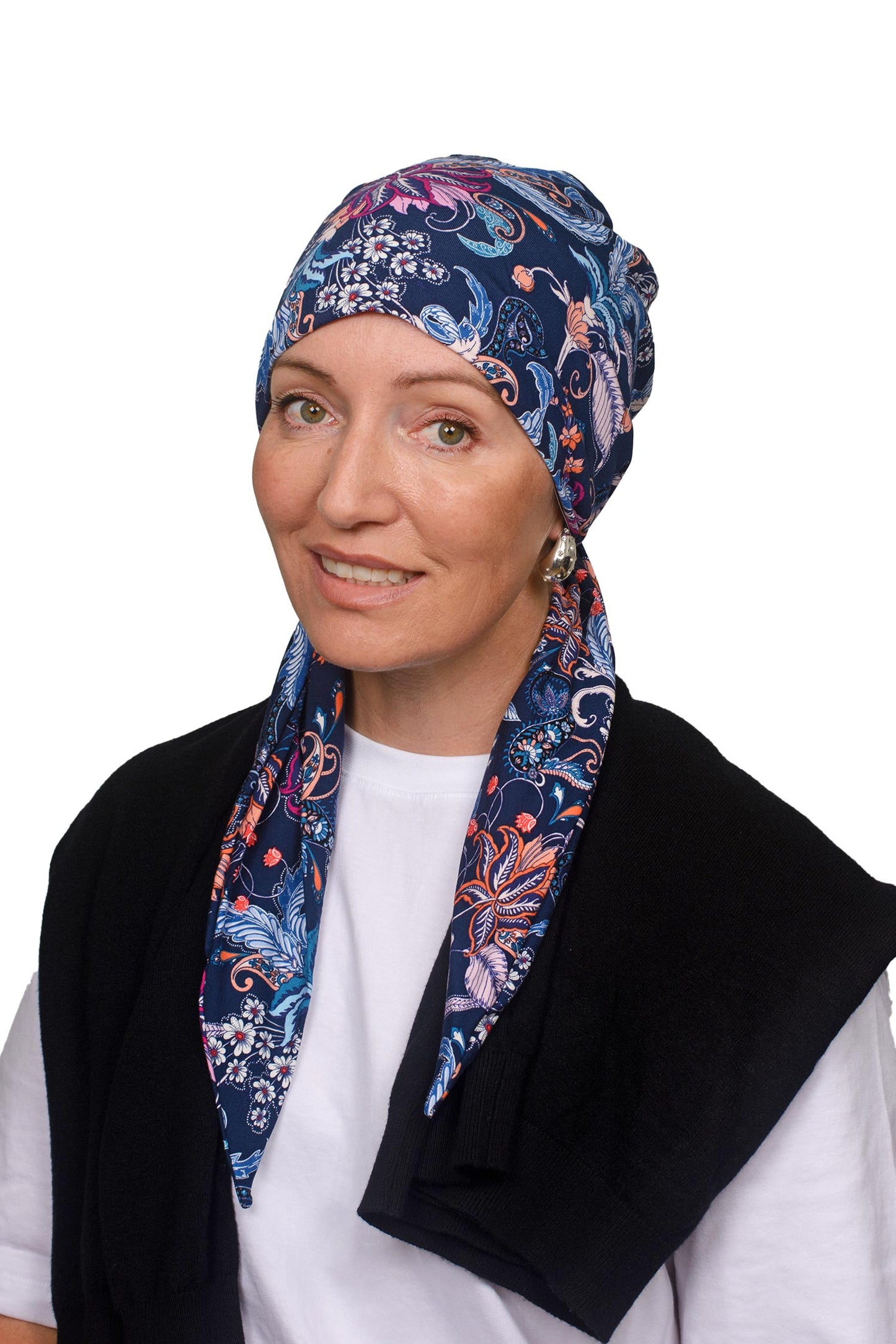 Women wearing a paisley and ink wrap hat as a head covering for cancer