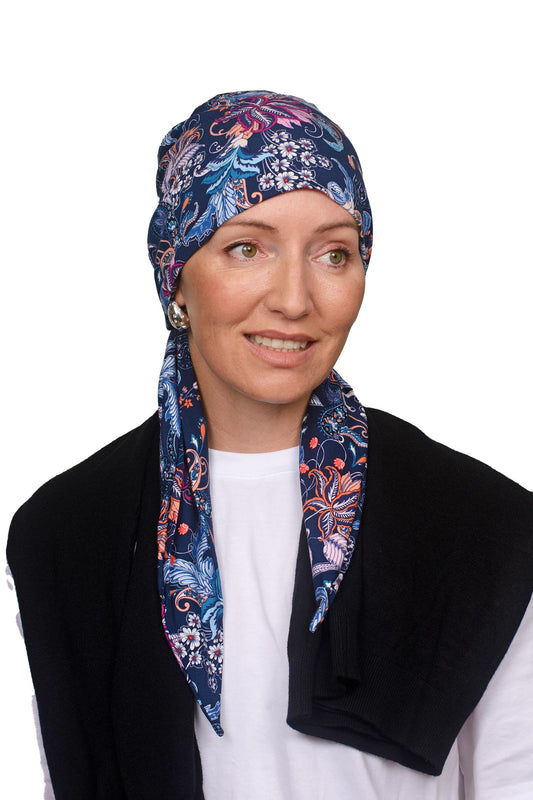 Women wearing a paisley and ink wrap hat as a head covering for cancer
