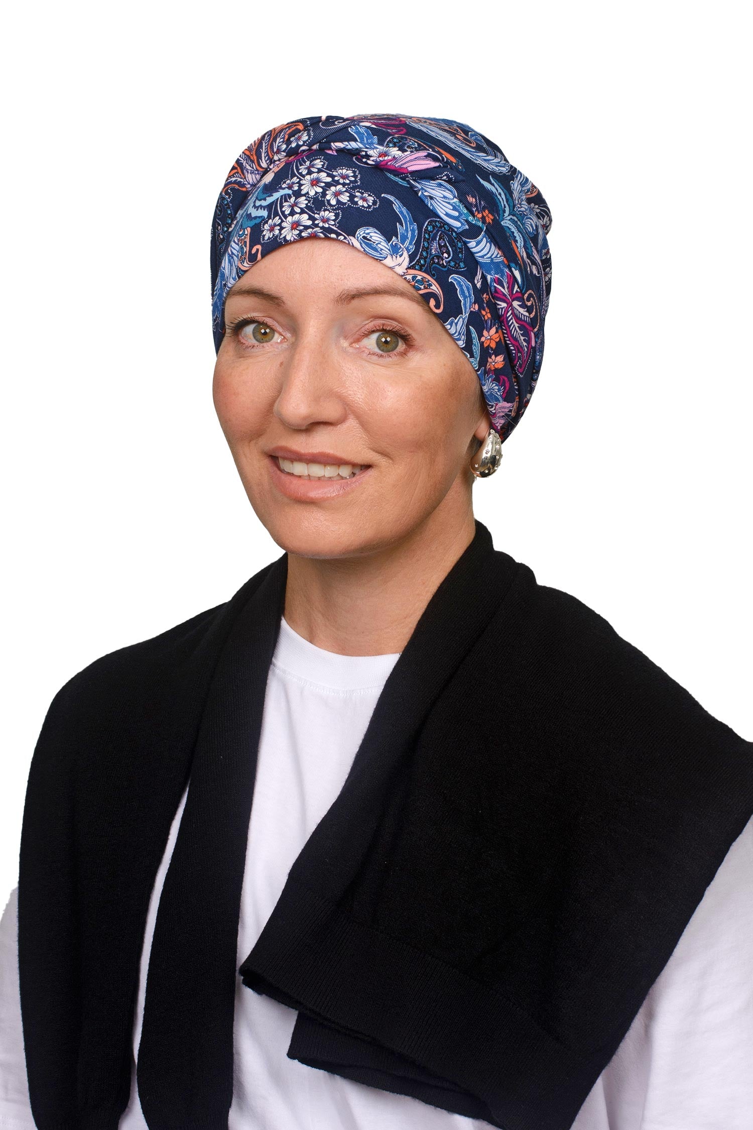 Women wearing a paisley and ink wrap hat as a head covering for cancer