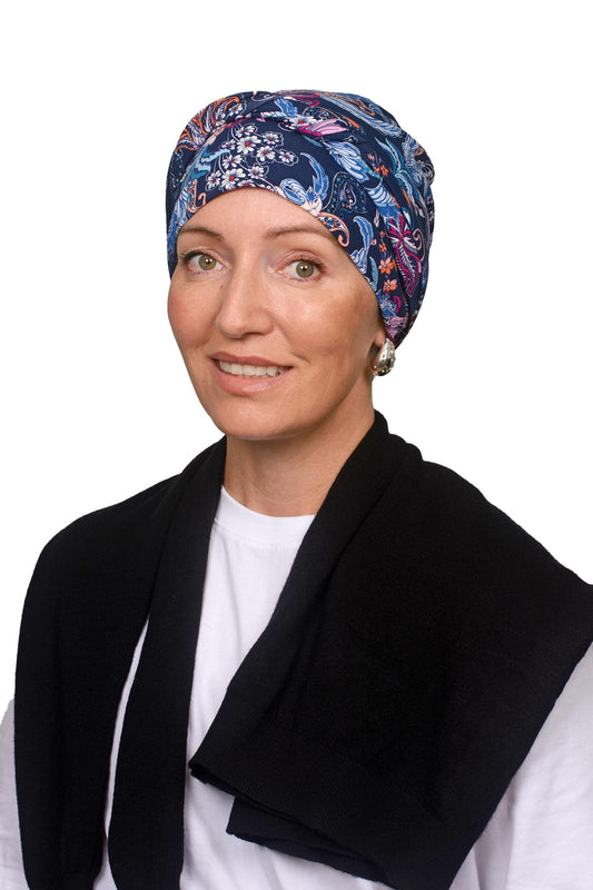 Women wearing a paisley and ink wrap hat as a head covering for cancer