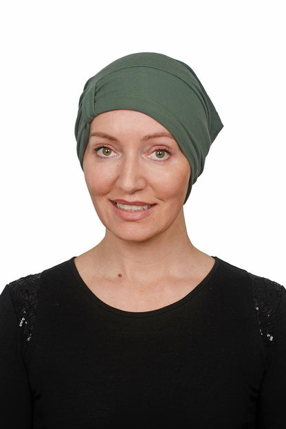 Woman wearing a green headscarf on a white background