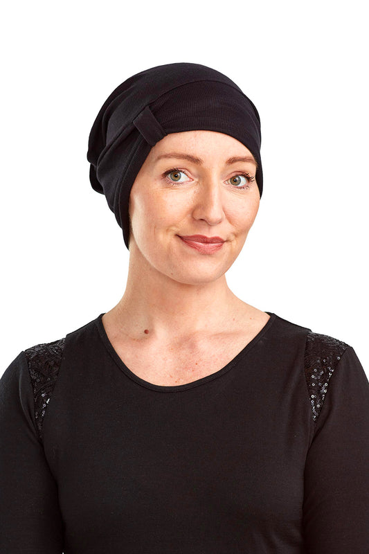 Women wearing a cancer beanie as a head covering