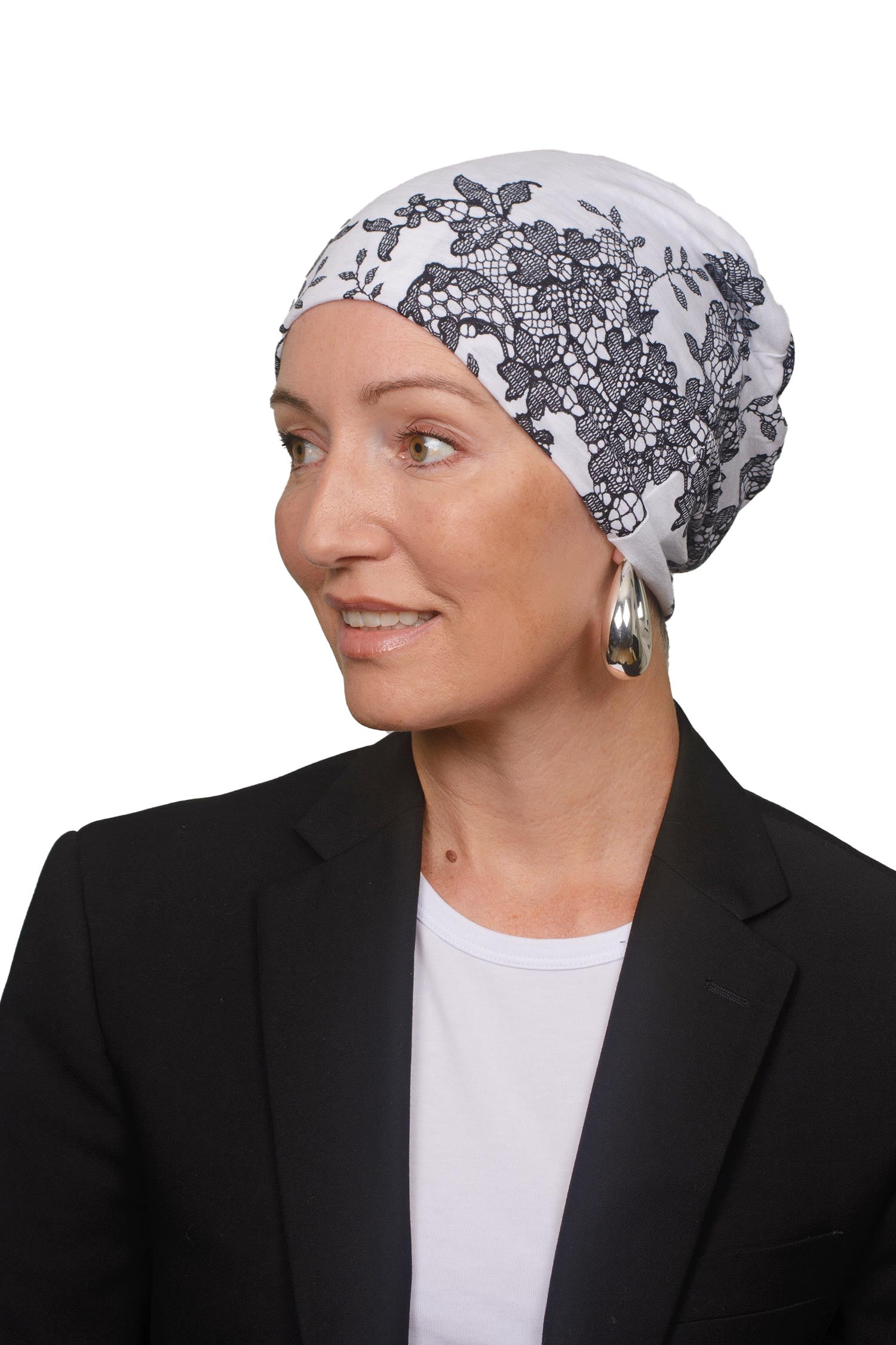 Women wearing a cancer nightcap in a lace print as a headcovering