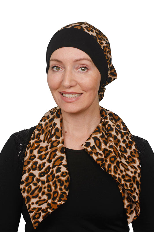 women wearing a cancer head scarf in an animal print with a black band and a scrunchie