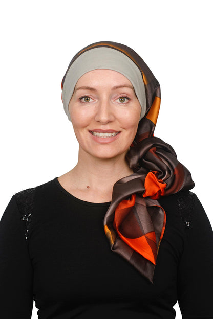 Women Wearing a Sand coloured band cancer scarf hat with a silky brown coloured scarf headcovering