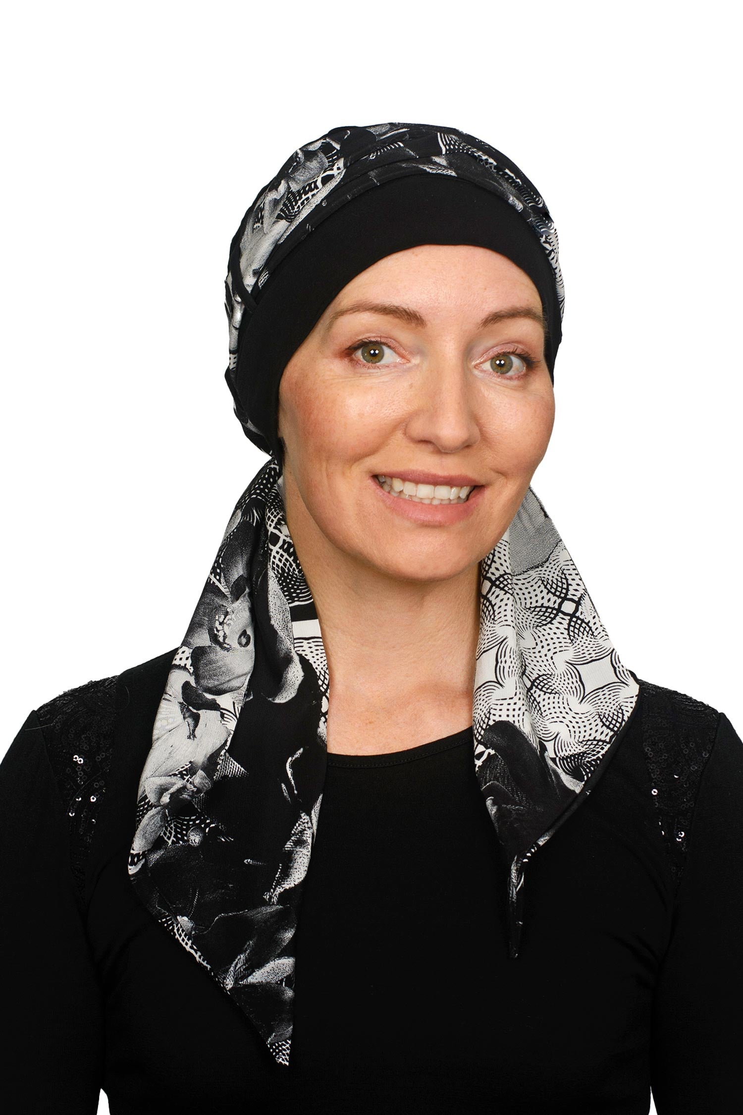 A women wearing a cancer cap with cancer headscarf in black and white colours as a headcovering.