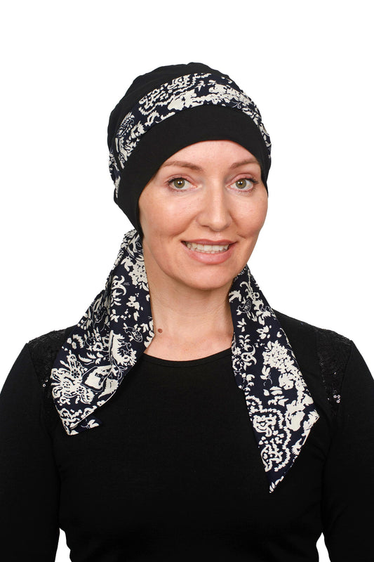 Women wearing a black cap with a black and white scarf for cancer as a headwrap