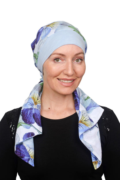 Women wearing a pansy print scarf cancer hat with a scrunchie and worn as a head covering