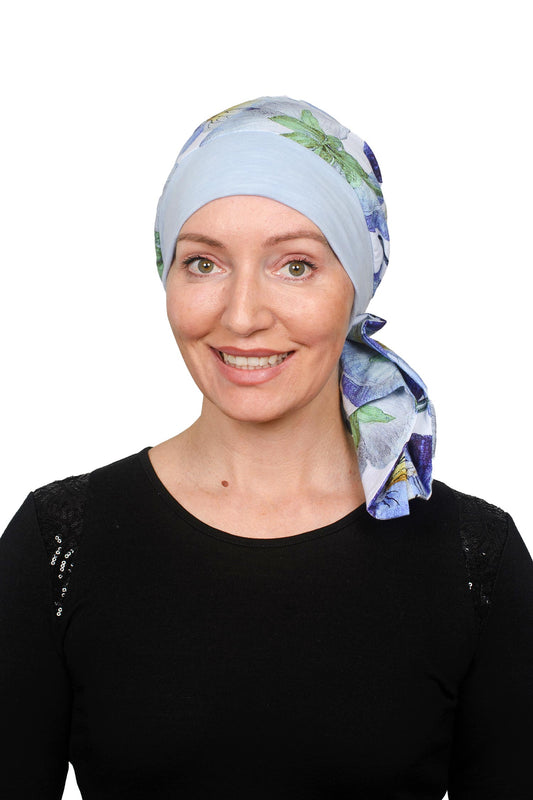 Women wearing a pansy print scarf cancer hat with a scrunchie and worn as a head covering