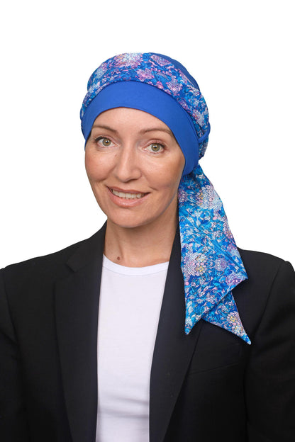Women wearing a cancer cap with a head scarf in it in blues and paisley print as a head covering