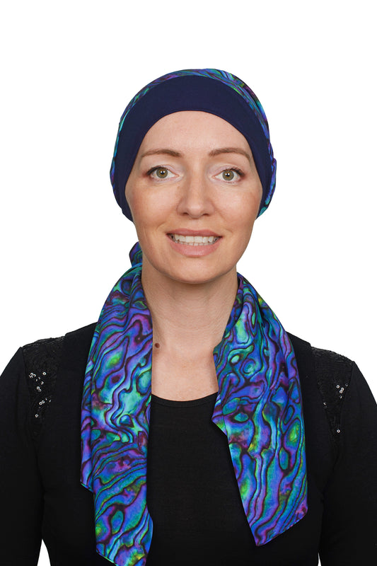 women wearing a paua cancer scarf hat as a head covering ink and a paua nz design