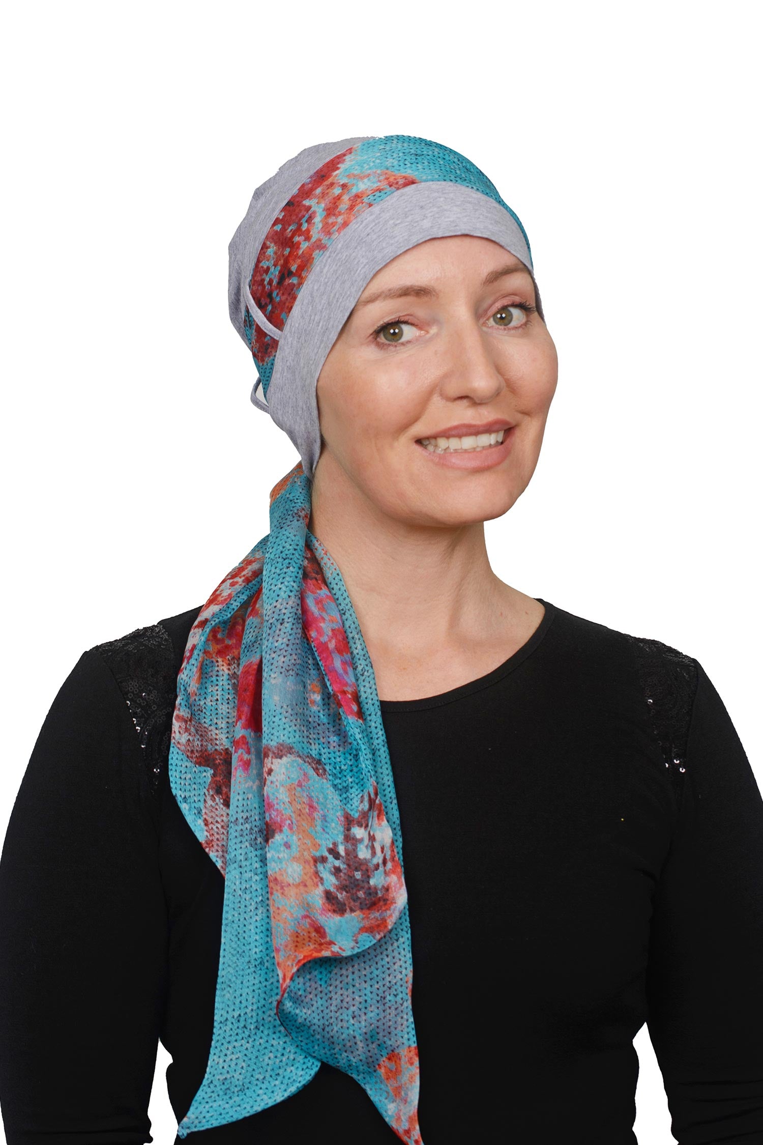 Women wearing a headcovering cancer scarf with cap in a silver and abstract aqua design seperate scarf in silk