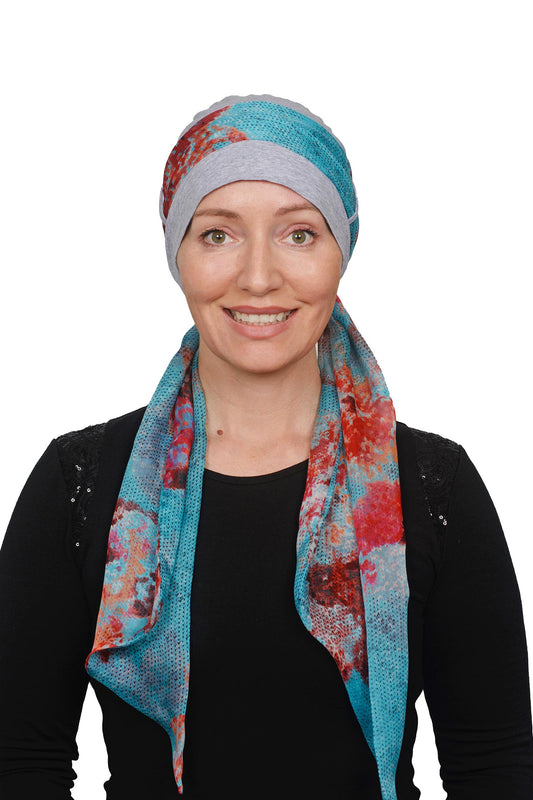 Women wearing a headcovering cancer scarf with cap in a silver and abstract aqua design seperate scarf in silk