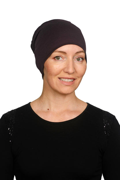 Women wearing a cancer hat in a dark purple as a head covering.