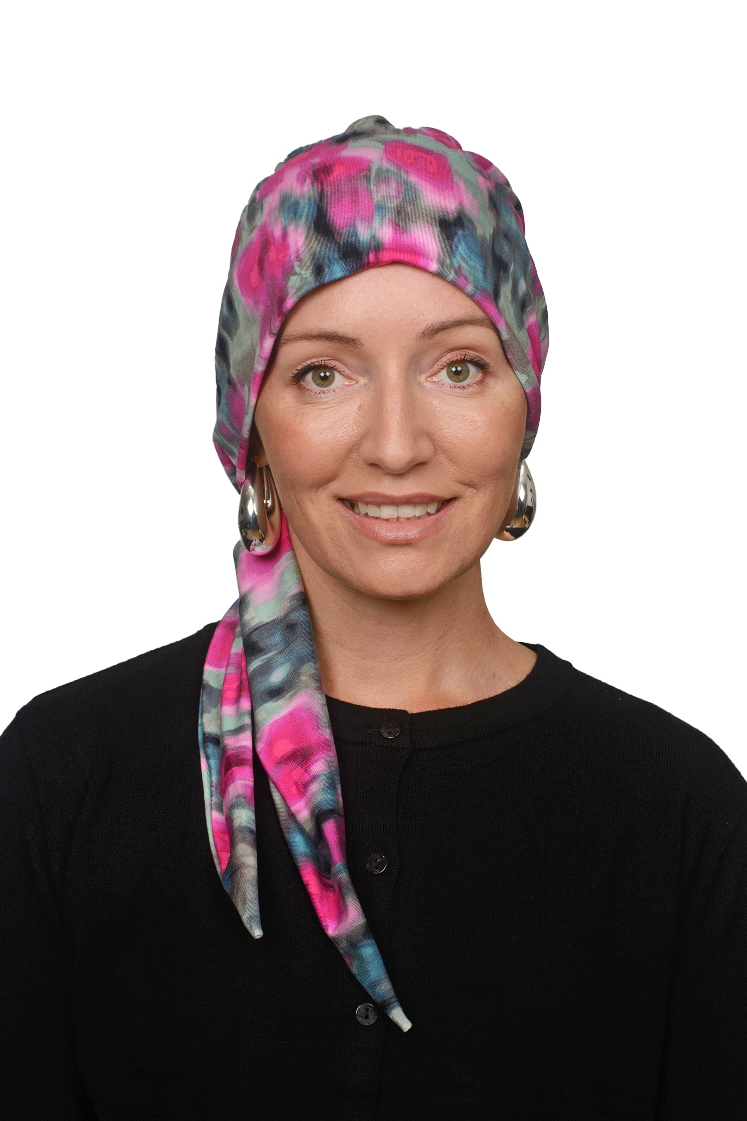 women wearing a cancer hat covering in pink and green wrapped around her head as a head covering