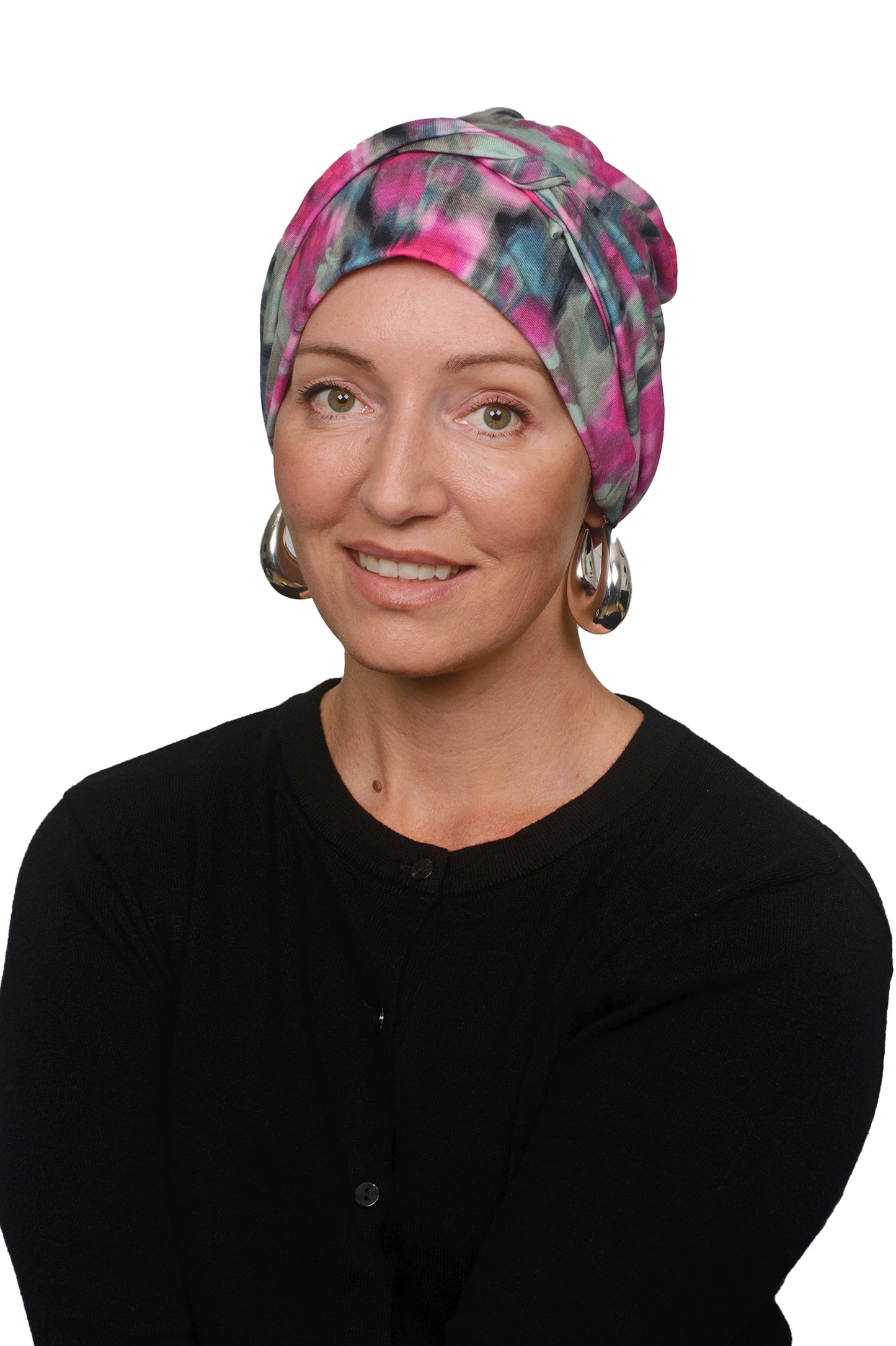 women wearing a cancer hat covering in pink and green wrapped around her head as a head covering