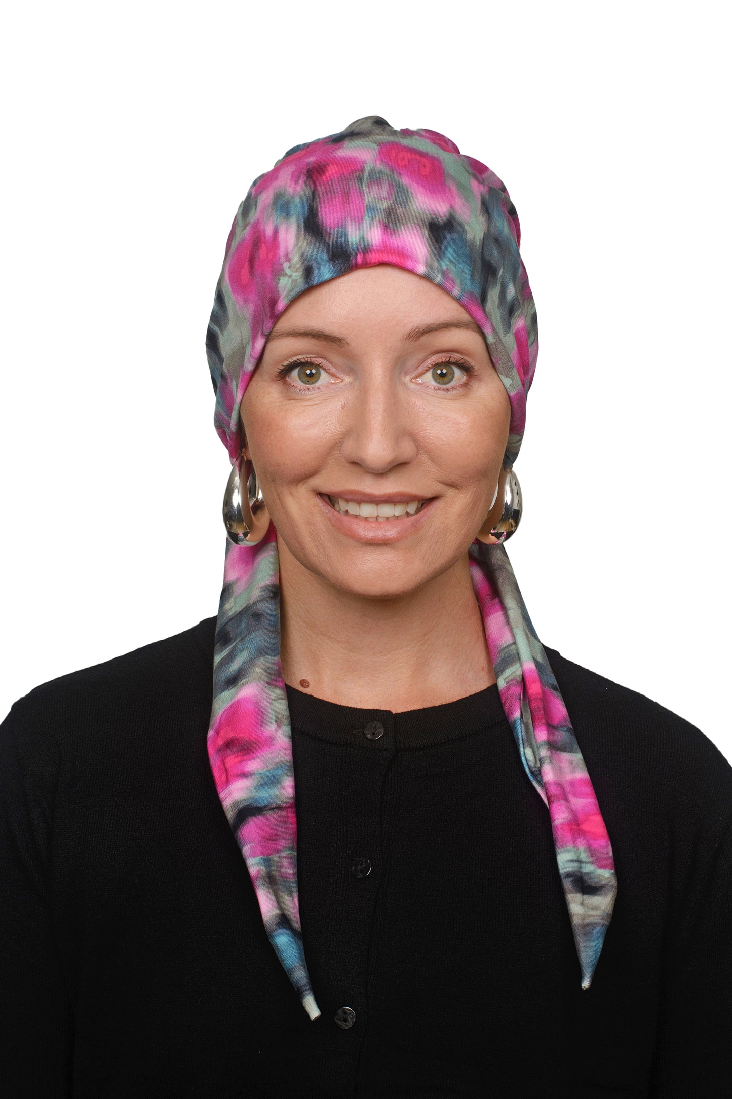 women wearing a cancer hat covering in pink and green wrapped around her head as a head covering