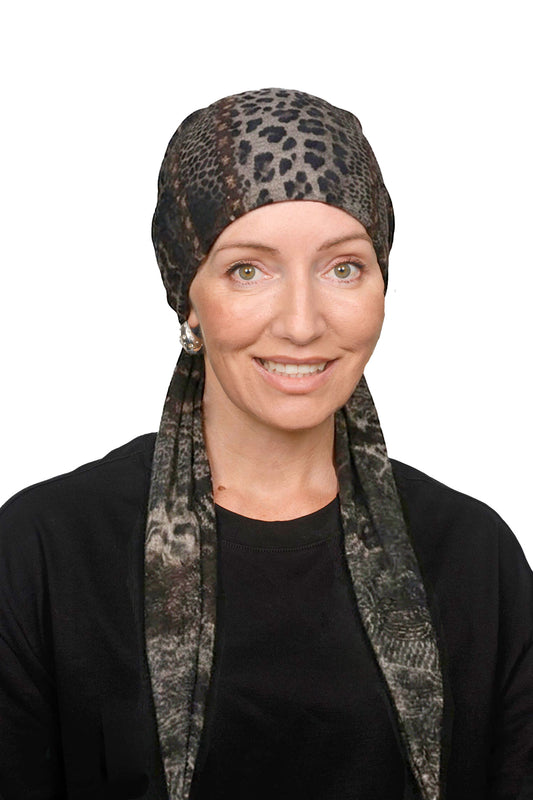 Women wearing a cancer head scarf as a head covering in an animal print.