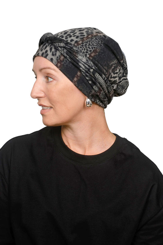Women wearing a cancer head scarf as a head covering in an animal print.