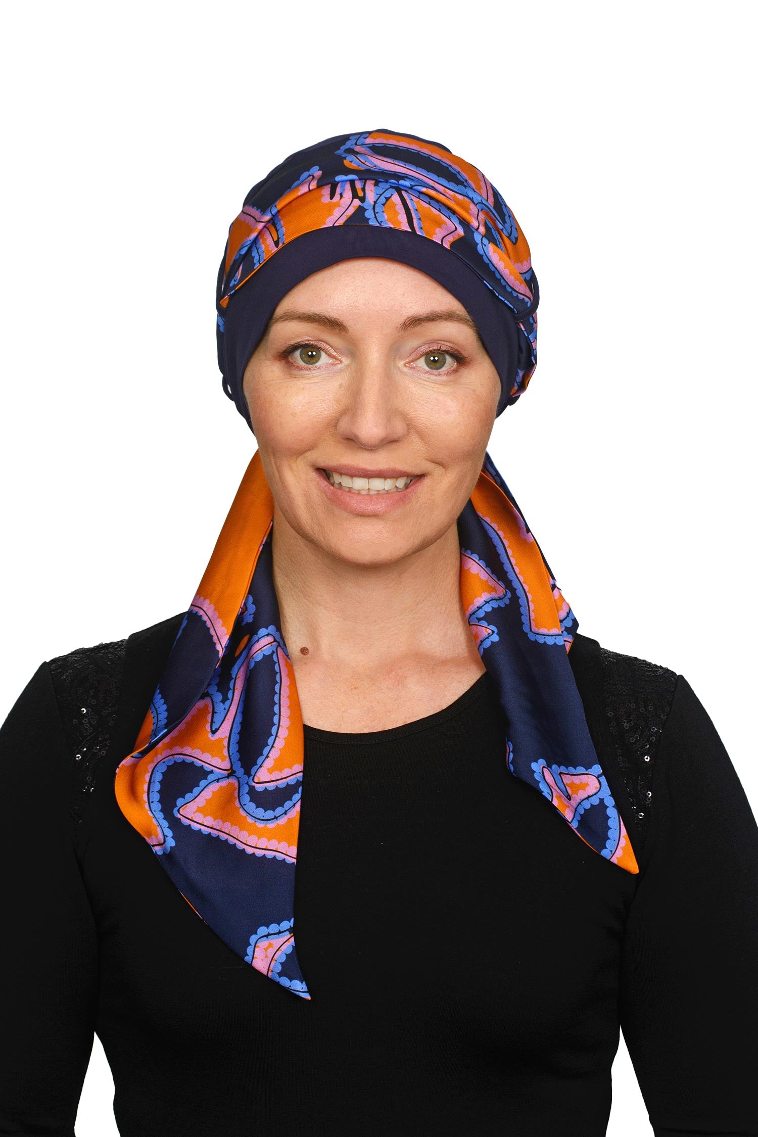 Women wearing an ink cancer hat with a bright coloured scarf headcovering
