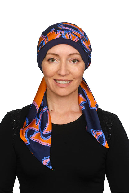 Women wearing an ink cancer hat with a bright coloured scarf headcovering