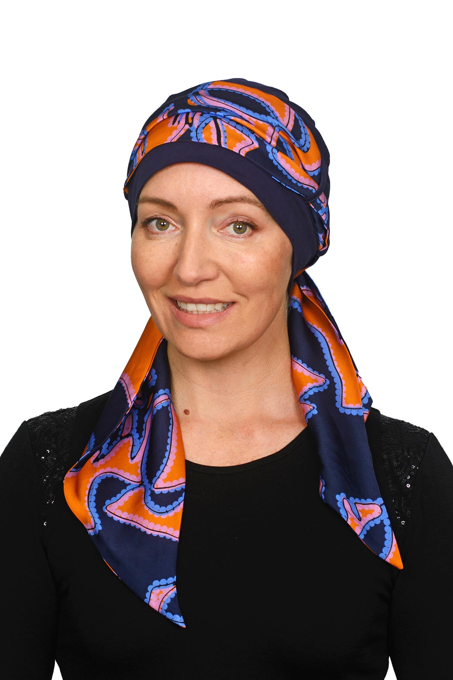 Women wearing an ink cancer hat with a bright coloured scarf headcovering
